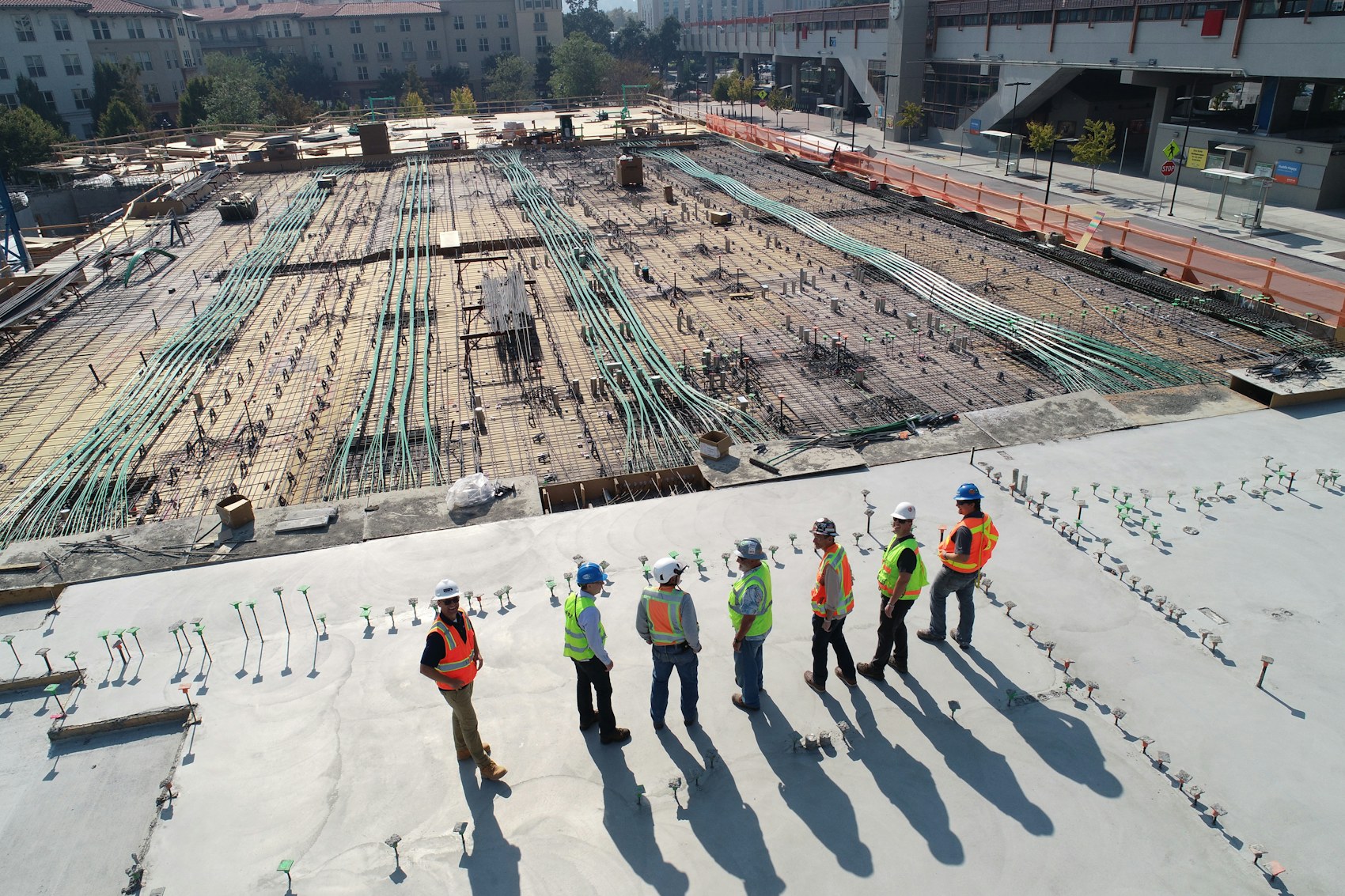 Construction site with structural frame and workers (illustrative image)